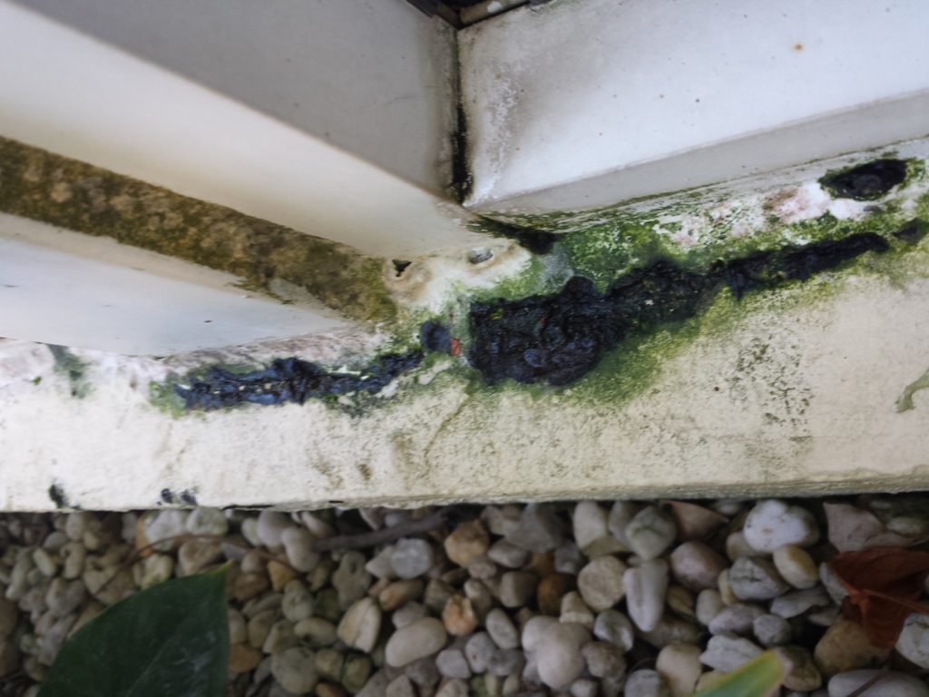 Sliding glass patio door frame caulking replacement needed on the frame perimeter.