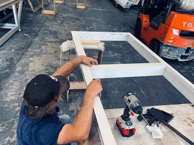 Aldora impact storefront window frames being assembled in our Broward county facility.