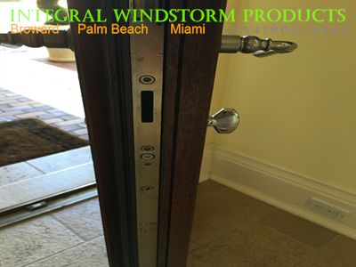 Hoppe Stainless steel Multipoint door lock installed in a mahogany door.